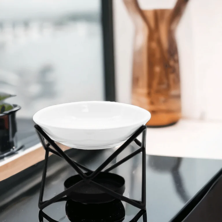 Ceramic and metal decorative hex stand displayed on a flat surface.