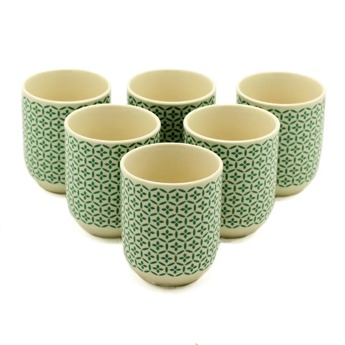 Stylish green mosaic tea drinking cups displayed against a neutral background