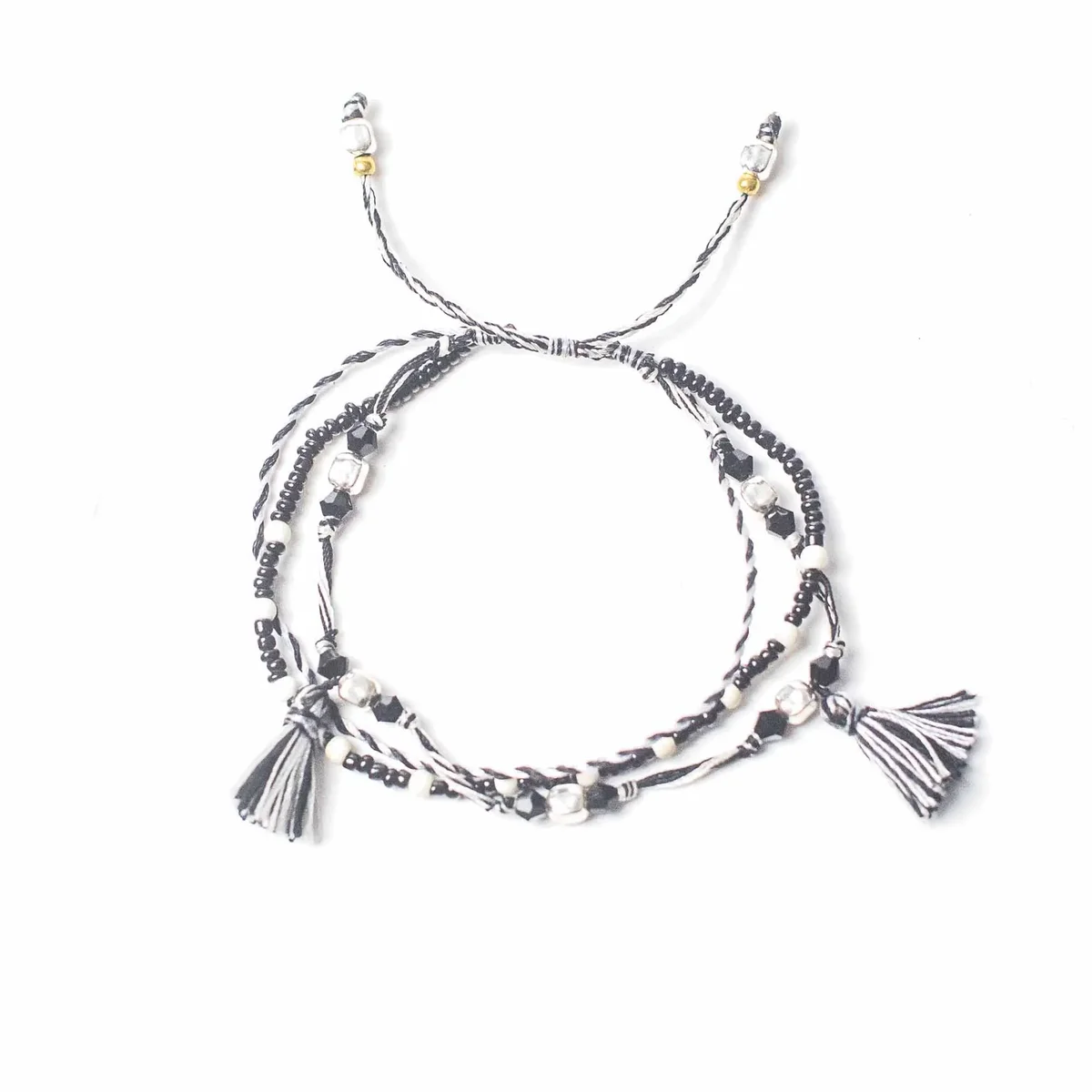 Temple string bracelet – Balance of Nature bracelet, featuring a woven band with simple metal charms.