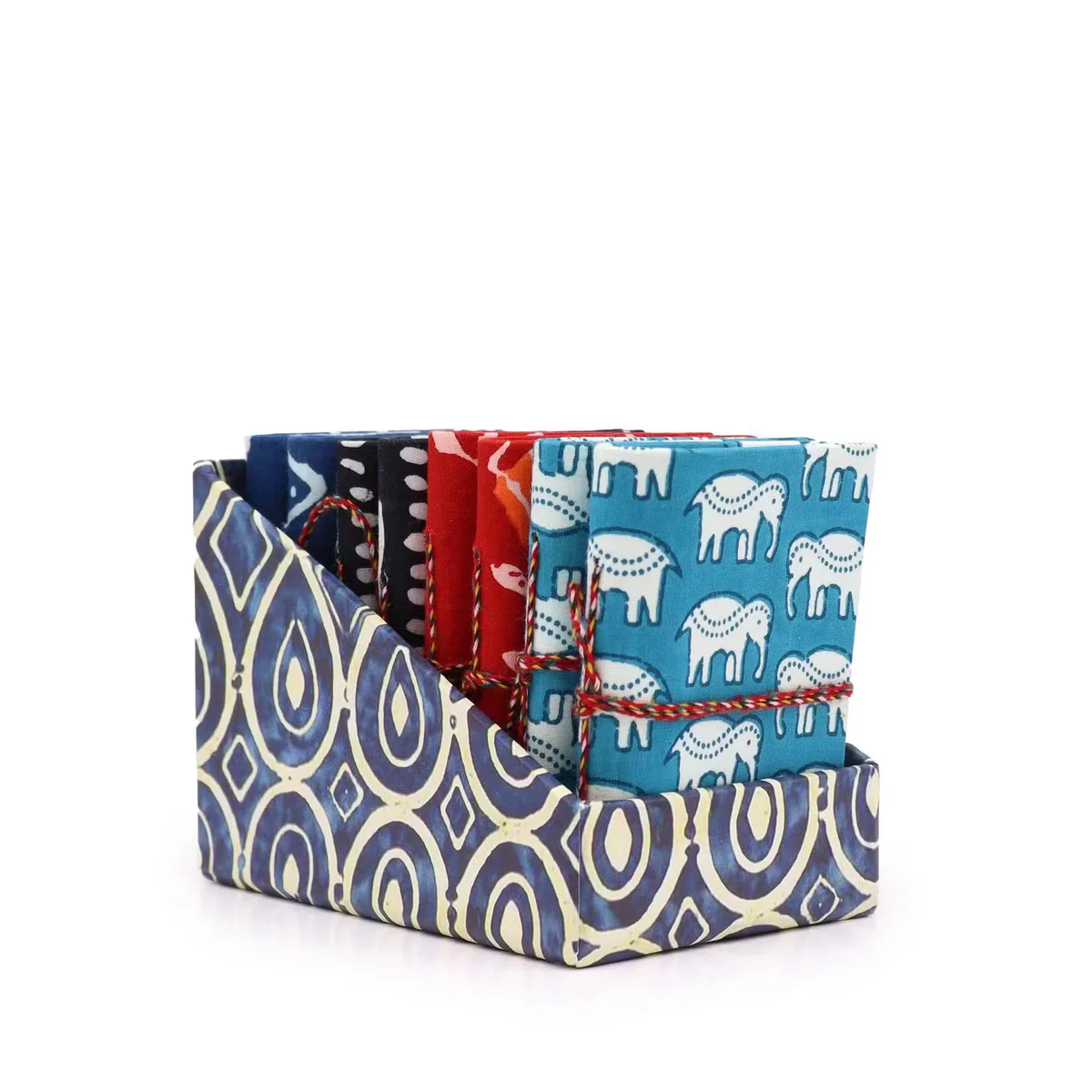 Stack of small notebooks 7x10cm with block print covers in assorted colors.
