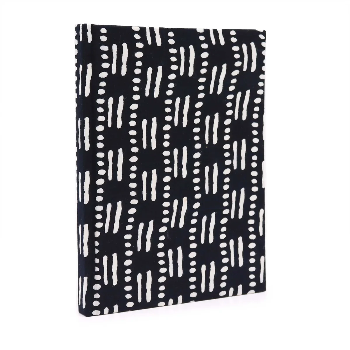 Elegant black‑dot notebooks on a light wooden surface, each 20x15cm, arranged in a tidy stack.