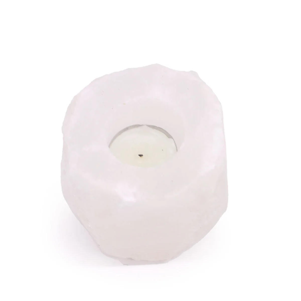 Himalayan salt candle holder made from crystal rock, weighing between 600-800g, glowing softly with candle light