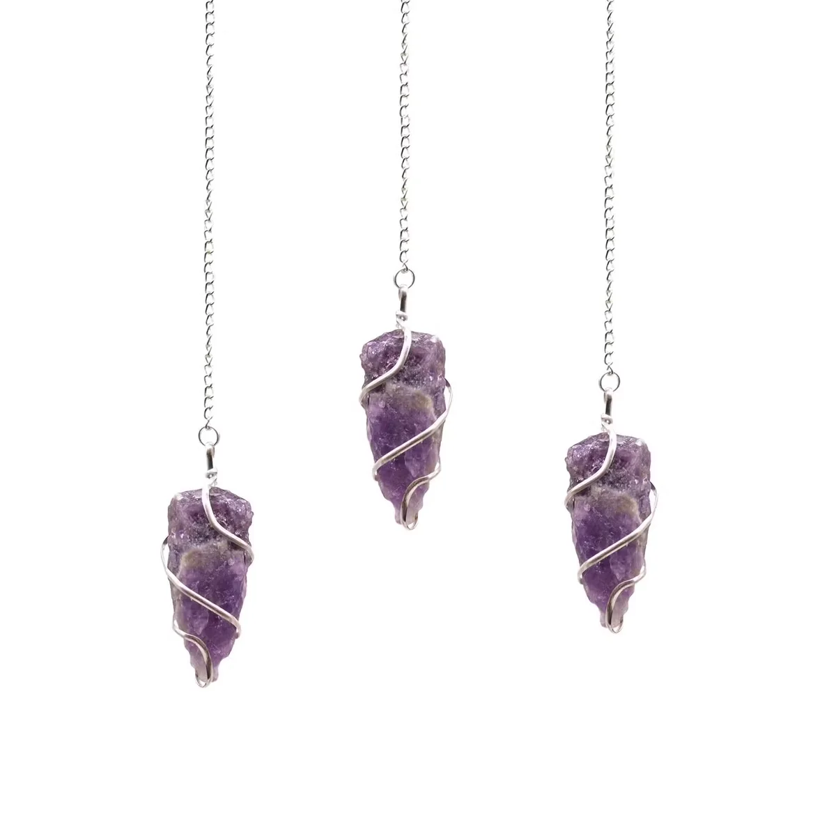 Raw amethyst crystal healing pendulum with pointed gemstone on a silver chain against a white background