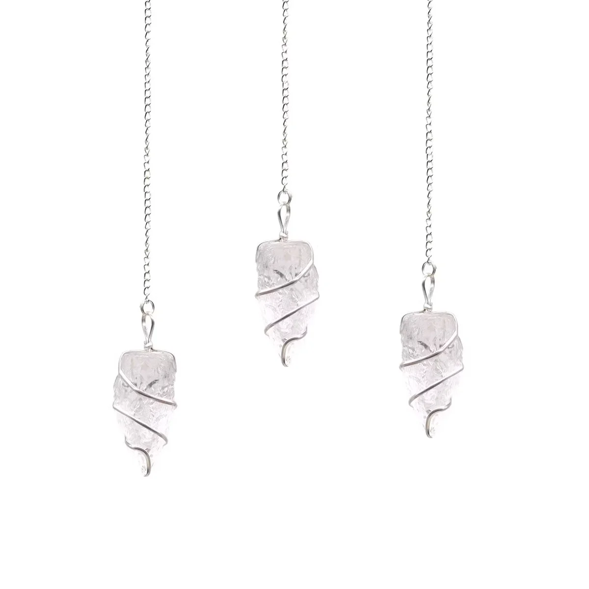 Raw rock quartz crystal healing pendulum with pointed tip and silver chain on white background