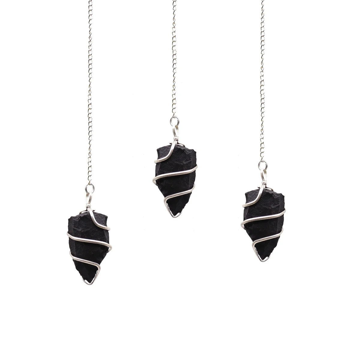 Raw black agate pendulum with a pointed gemstone and metal chain on a white background