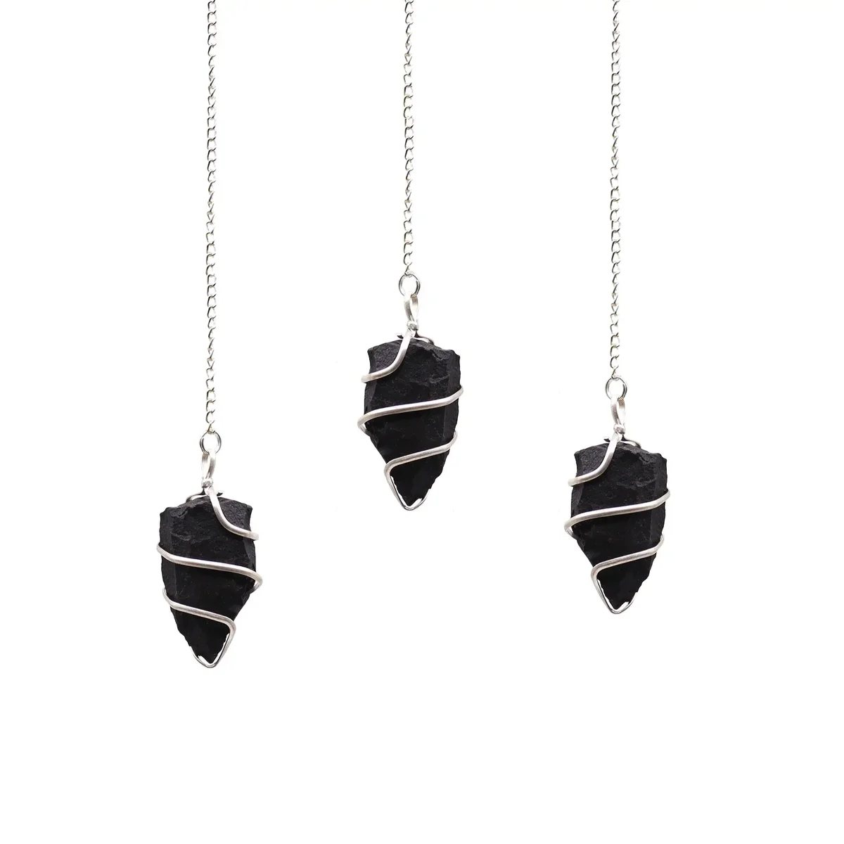 Raw gemstone pendulum made of polished black agate with a pointed tip and metal chain on white background