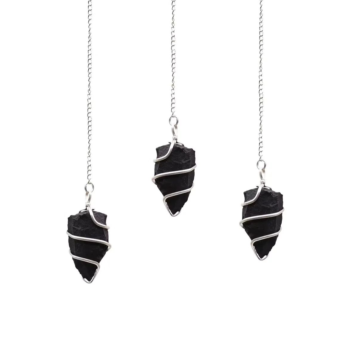 Raw black agate gemstone pendulum with silver chain, styled as a pendulum necklace UK accessory on white background