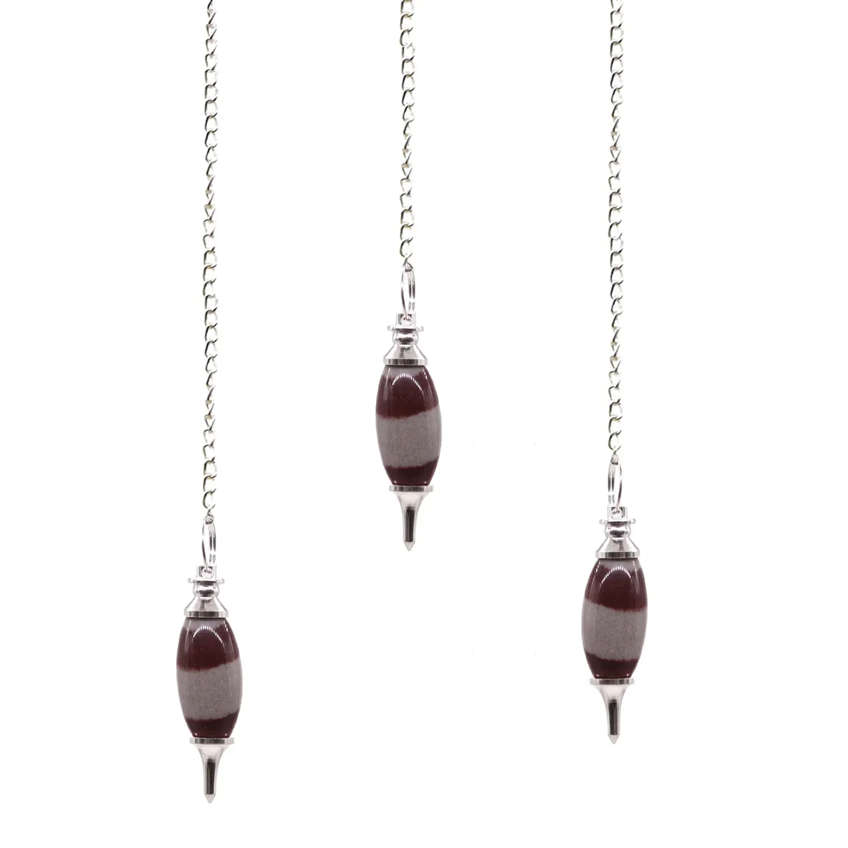 Shiva Lingam ornament with a pointed pendulum resting on a polished stone base against a white background