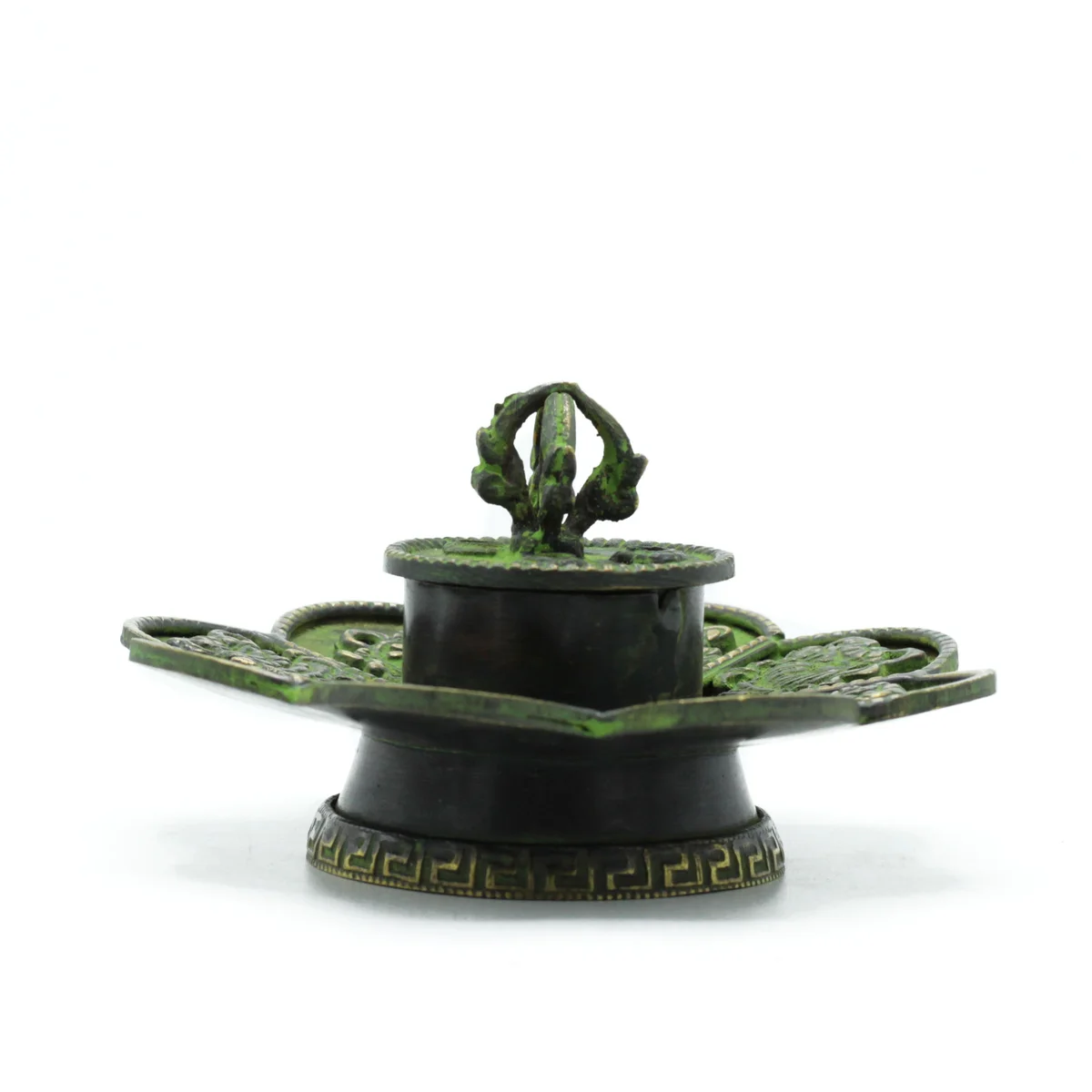 Brass verdigris incense holder with Tibetan eight symbols, designed for cone incense burning on a wooden surface