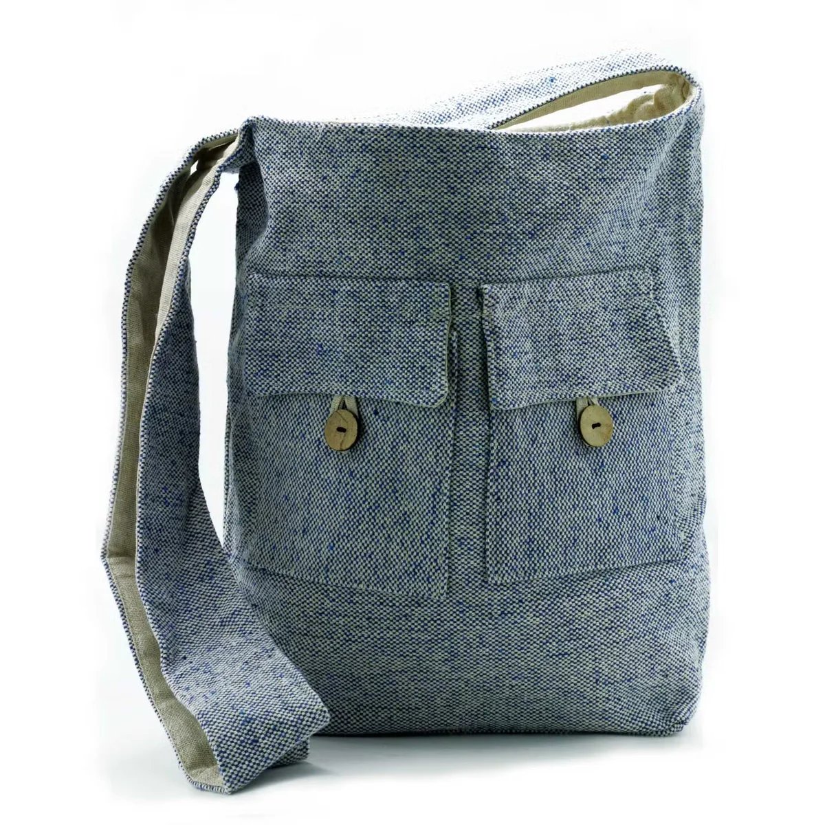 Large denim handbag with two front pockets in natural tones, designed for versatile everyday use