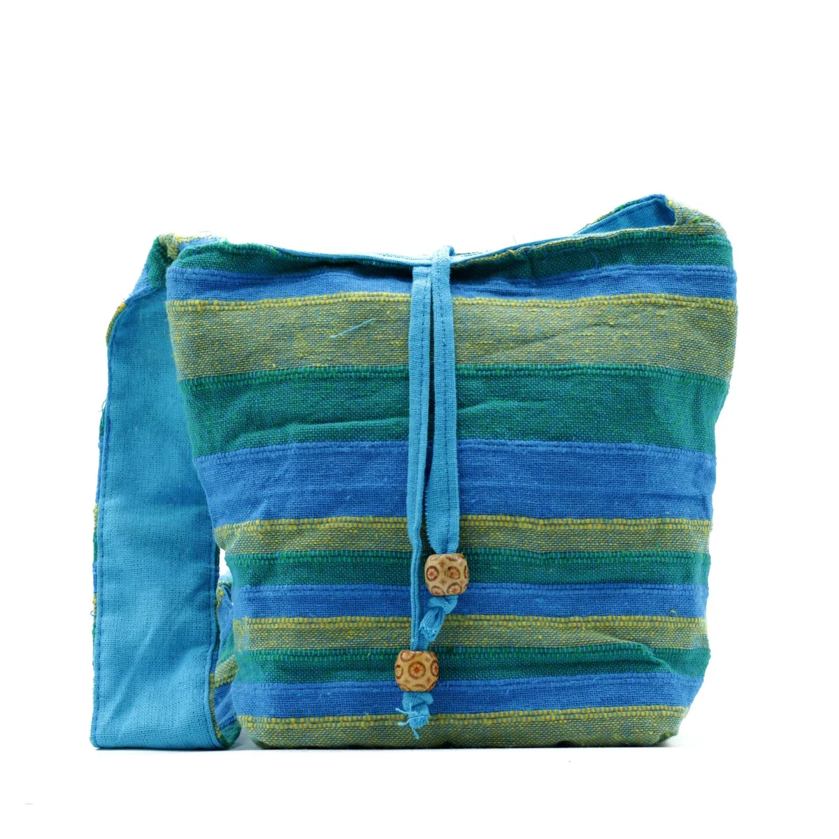 Nepal sling bag in green and blue with adjustable strap and front zipper pocket on white background