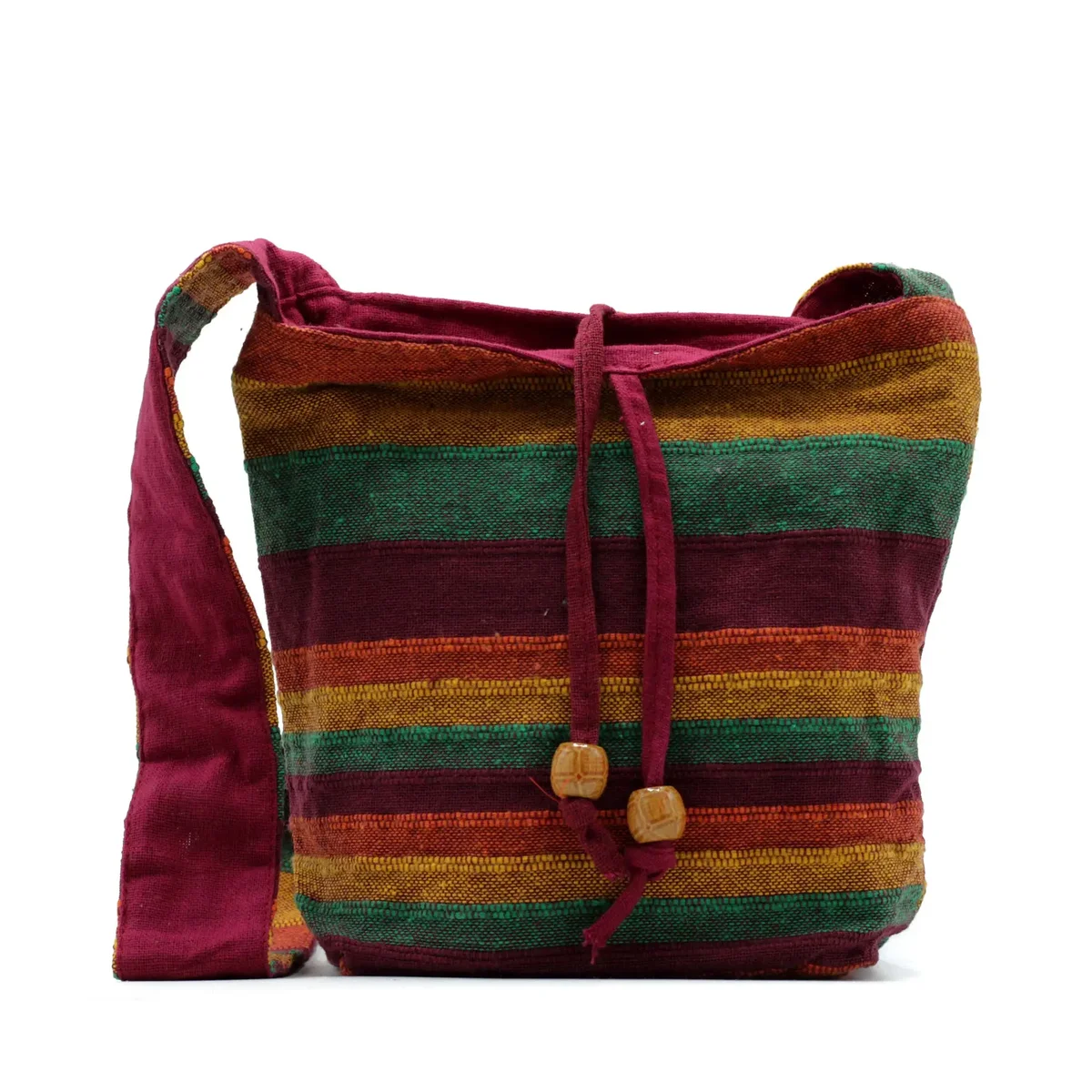 Tan and green Nepal sling mountain trek bag with adjustable strap and multiple compartments displayed on white background