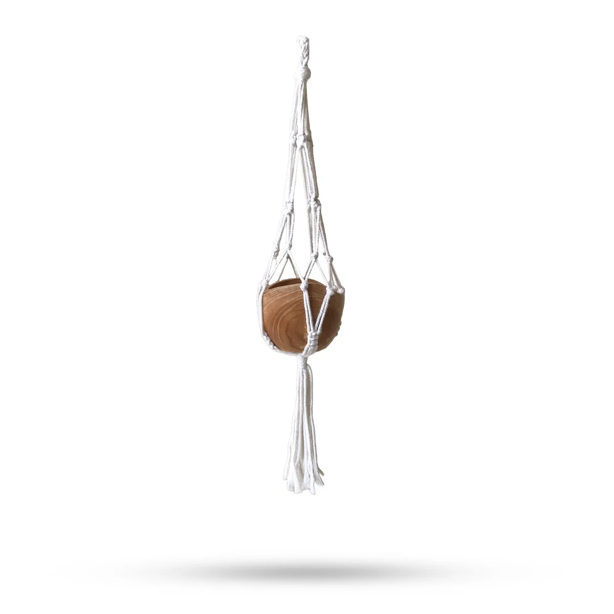 Macrame pot holder draped over a natural large pot