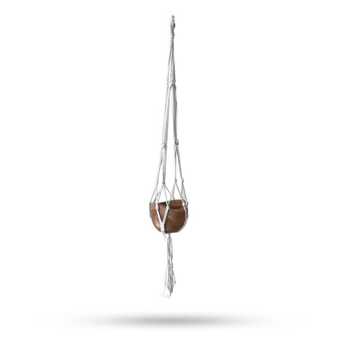 Handmade plant holder: macrame pot holder with natural cord framing a medium sized pot