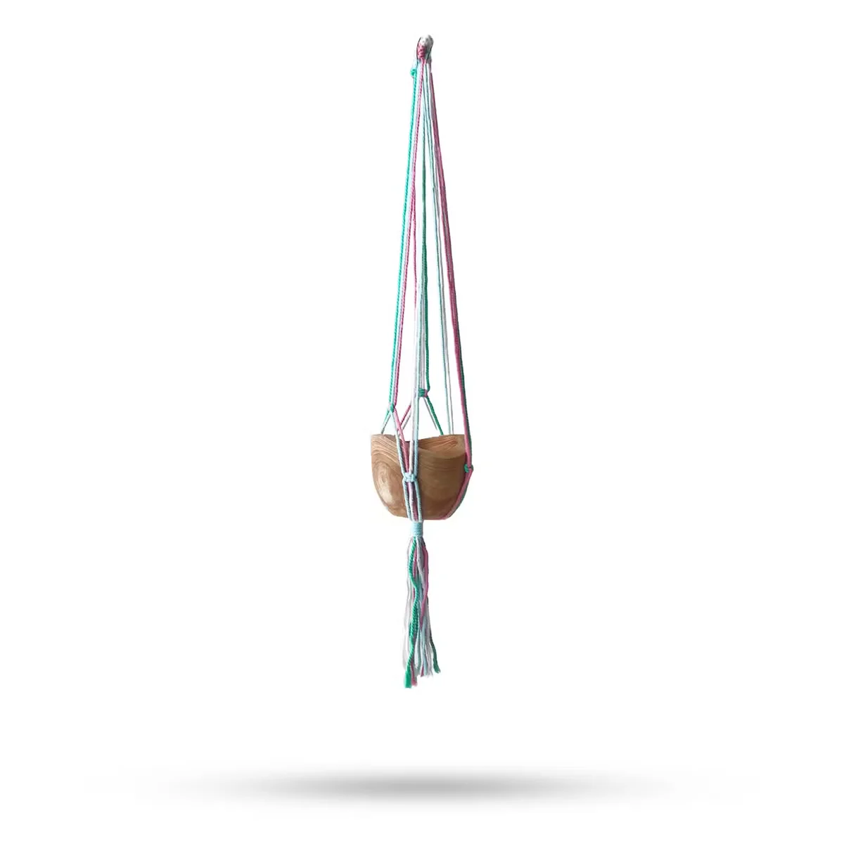 Macrame pot holder in pastel tones, holding a terrace med pot.