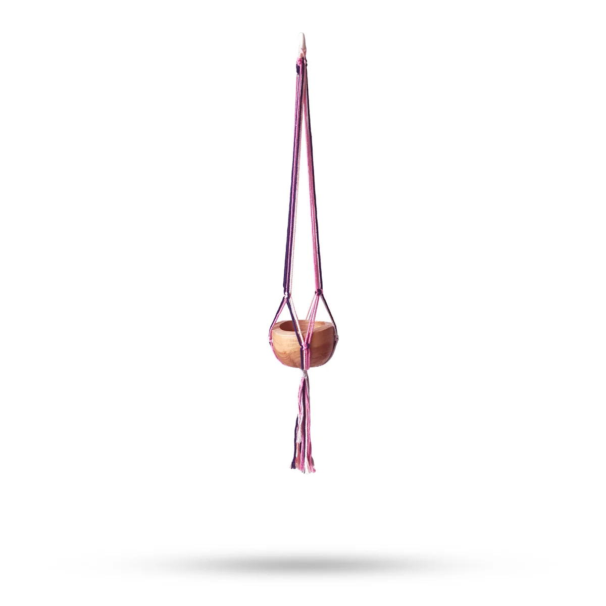 Macramé pot holder in pastel tones, medium size, hanging neatly as living room accessory