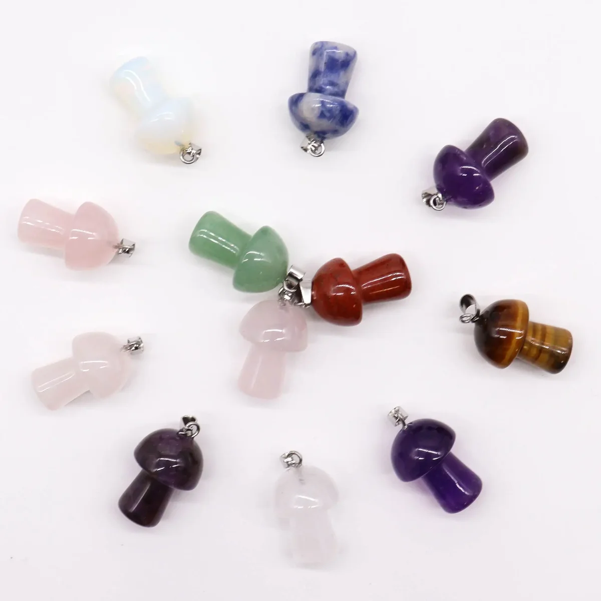 12 assorted gemstone pendants shaped like mushrooms, 20x15mm each, displayed together.