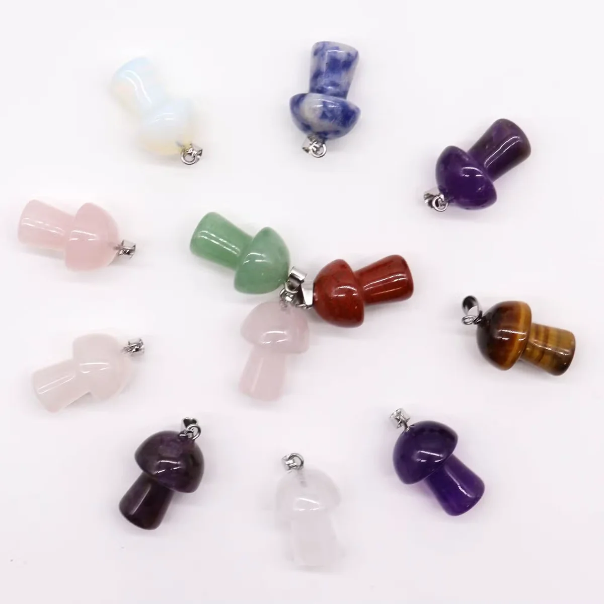 A collage of 12 assorted mushroom‑shaped gemstone charms, each 20x15mm, displayed on a neutral background.