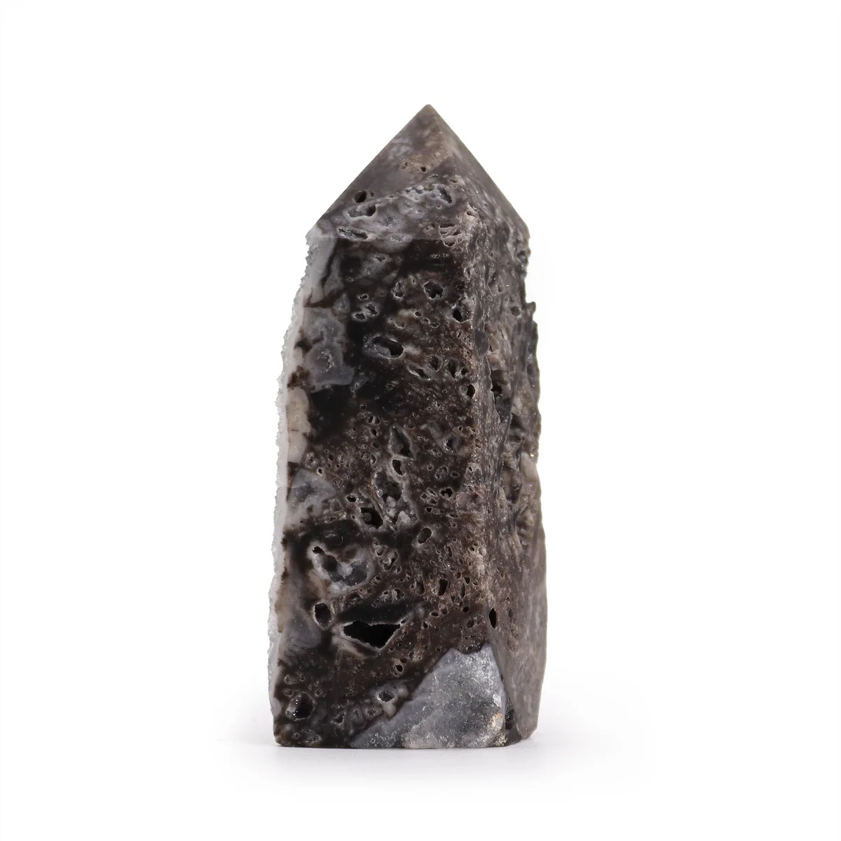 Tall calcite polish tower with smooth side surfaces standing upright on a white background