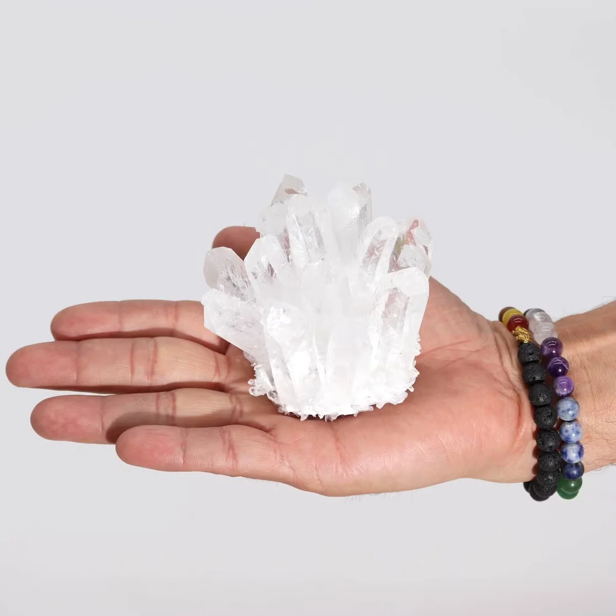 Clear quartz crystal cluster display with multiple pointed crystals forming a natural cluster arrangement