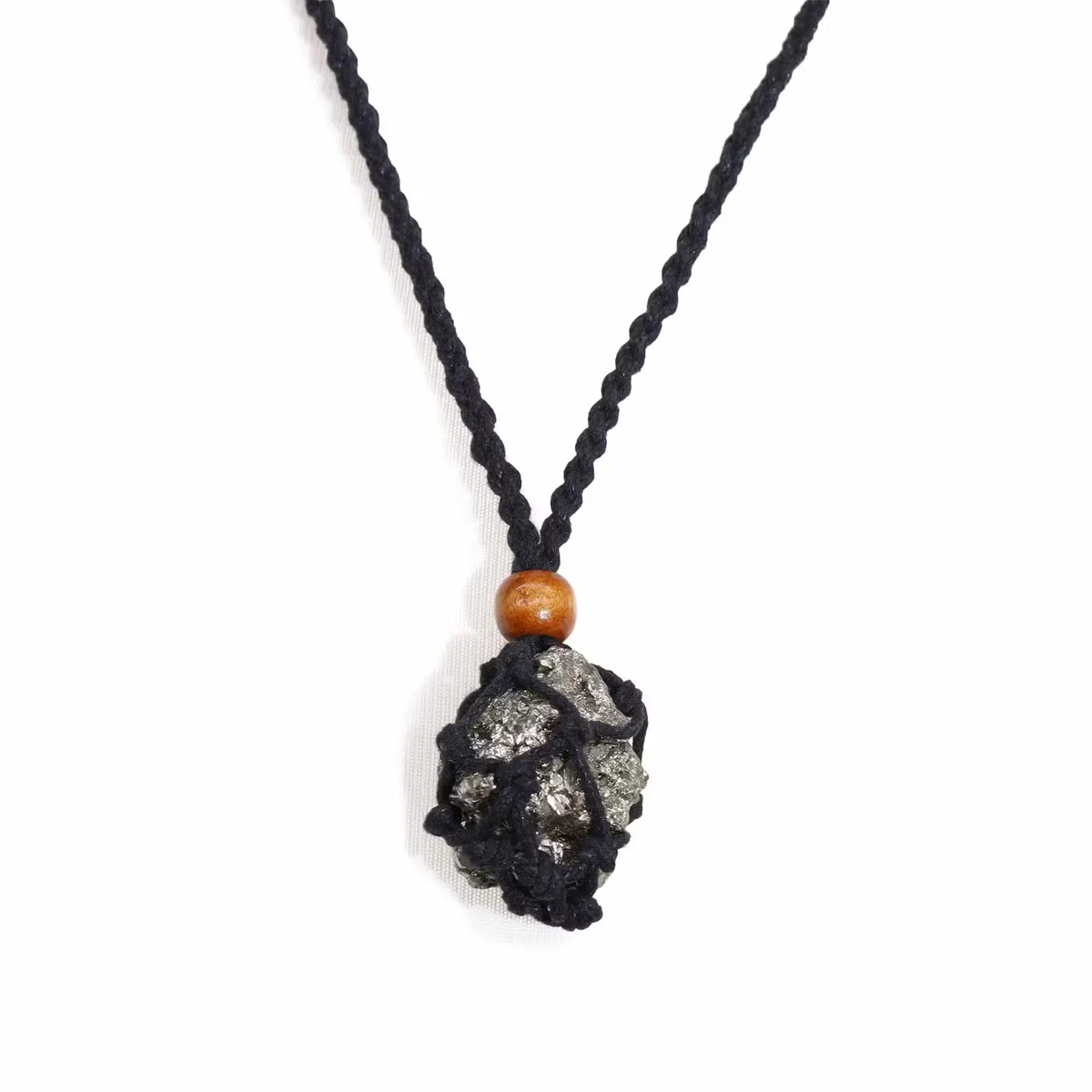 Black necklace cord for gemstones displayed coiled on a white background, showing texture and clasp details