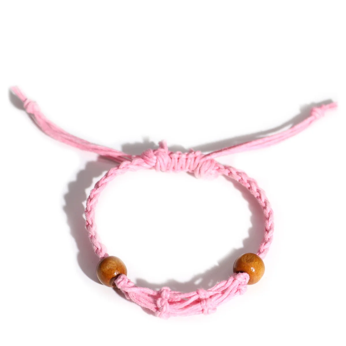 Close-up of a pink gemstone bracelet cord, showing smooth, vibrant pink beads strung on a durable cord