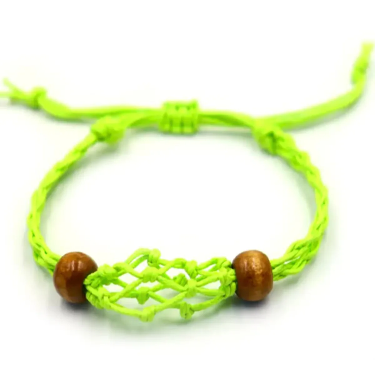 Green gemstone bracelet making cord coiled neatly on a white background for crafting jewelry designs