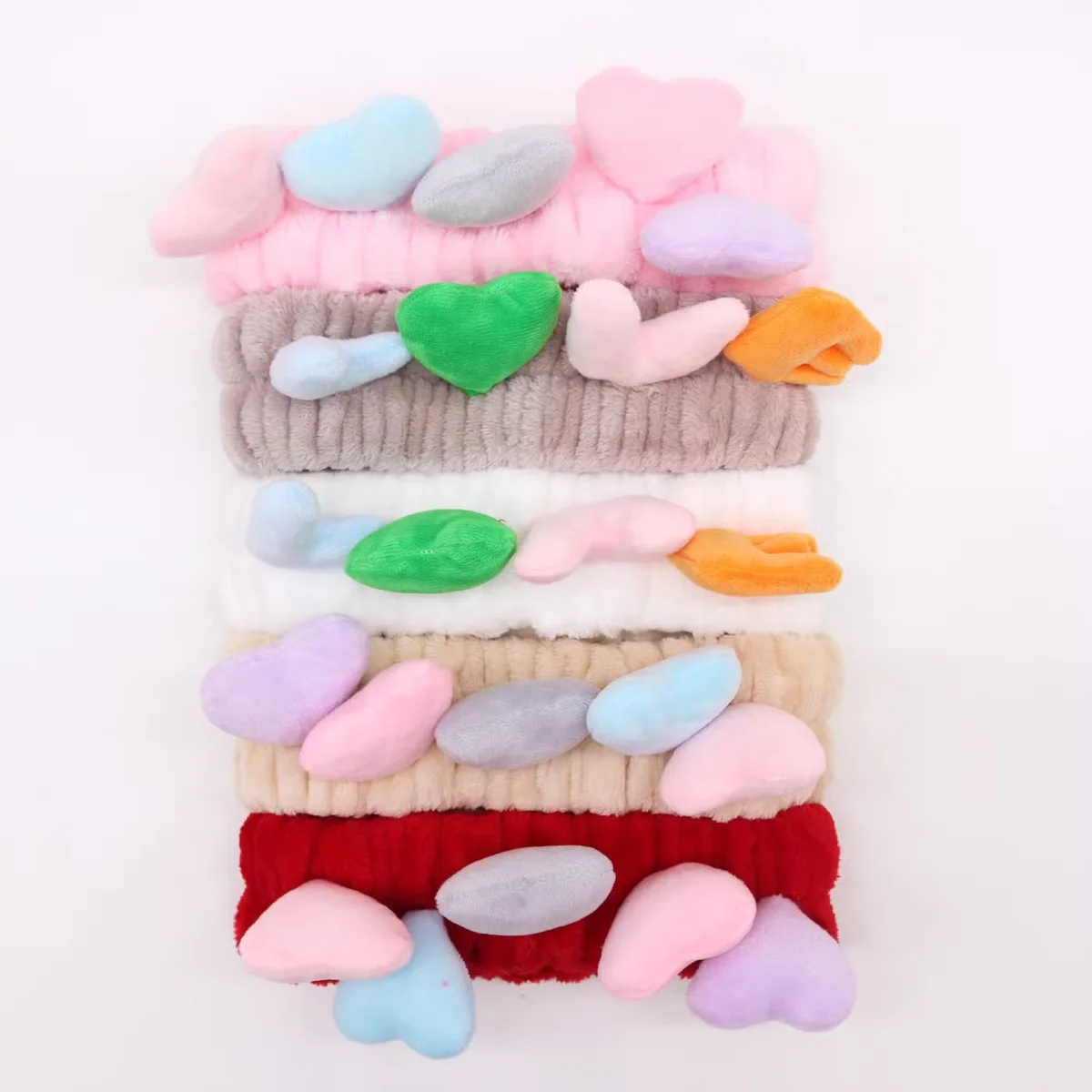 Assorted cute makeup headbands with love and hearts design, showcasing stylish hair bands for everyday use
