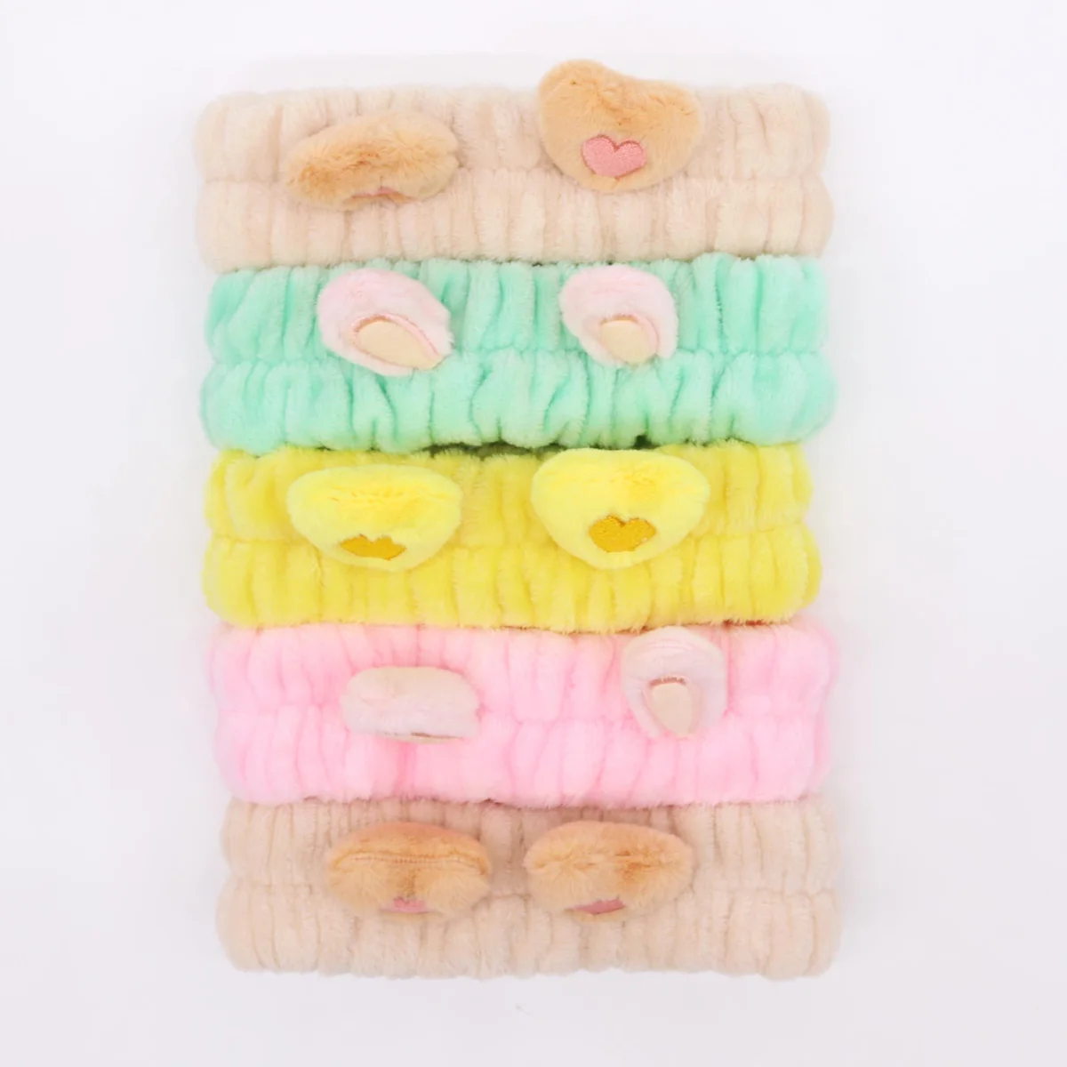 Assorted cute makeup headbands featuring heart and ear designs on a white background