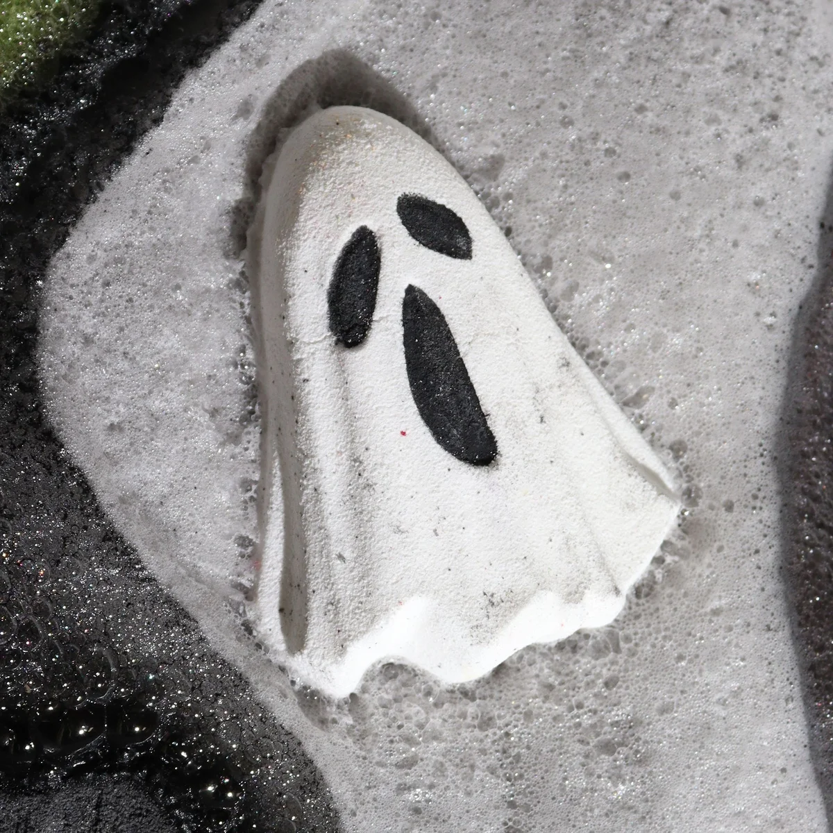 White ghost-shaped Halloween bath bomb weighing 65g on a plain background for festive bath time fun