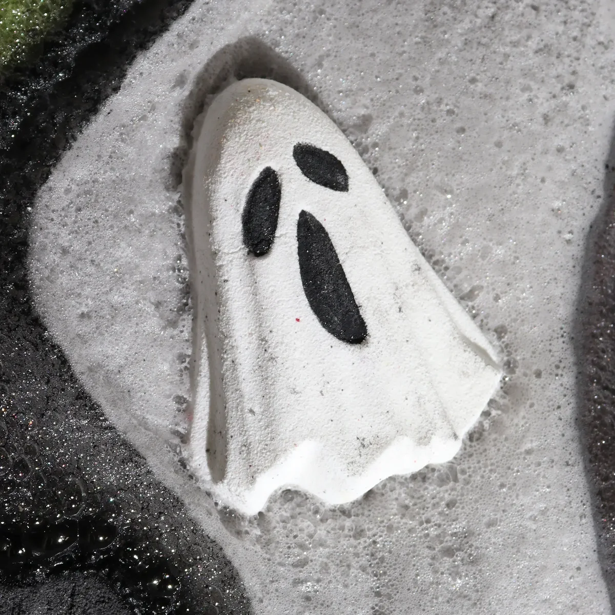 White ghost-shaped bath bomb with Halloween theme weighing 65g on a plain background, ghost bath bomb product view