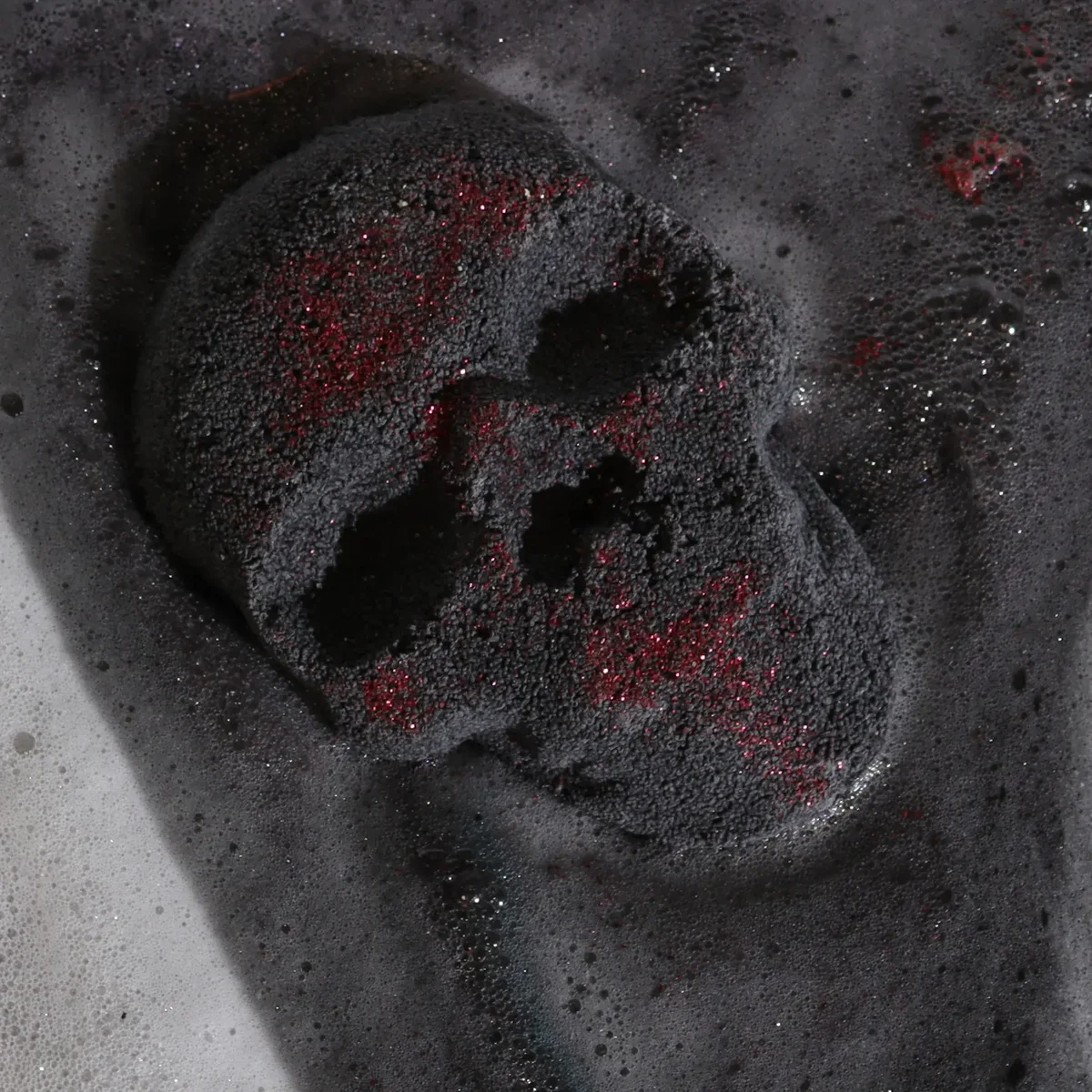White skull-shaped bath bomb weighing 40g with Halloween-themed design on a plain background