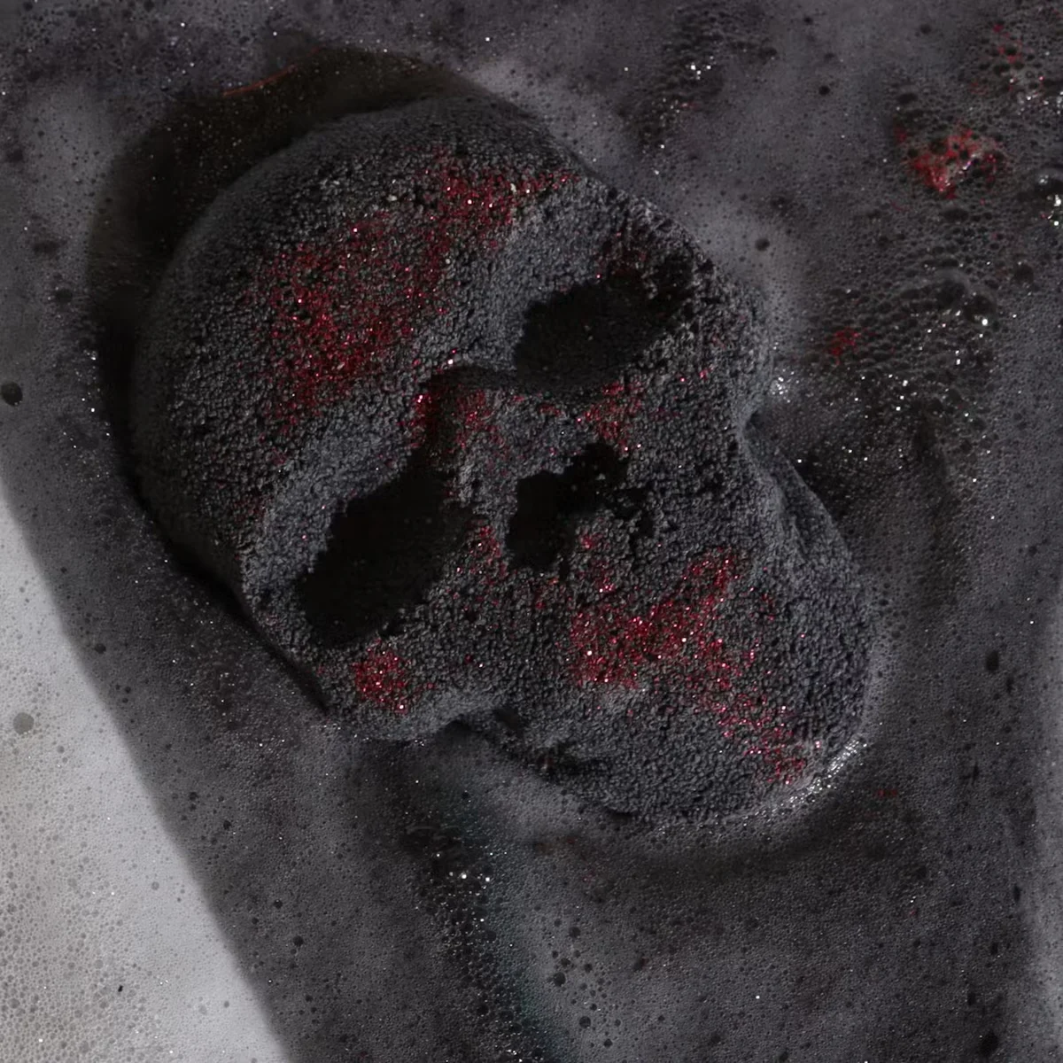 White skull-shaped Halloween bath bomb weighing 40g, part of Halloween bath accessories collection on plain background