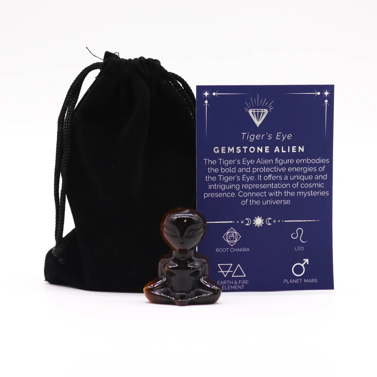 Tiger eye gemstone ornament shaped like an alien, showing warm amber stone.