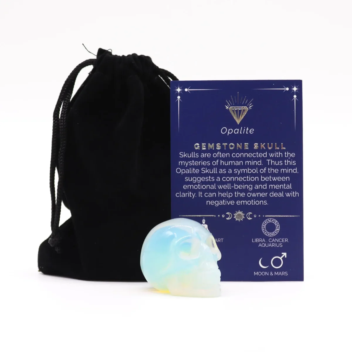 Small gemstone skull carved from opalite with smooth, polished surface and translucent blue-white hues
