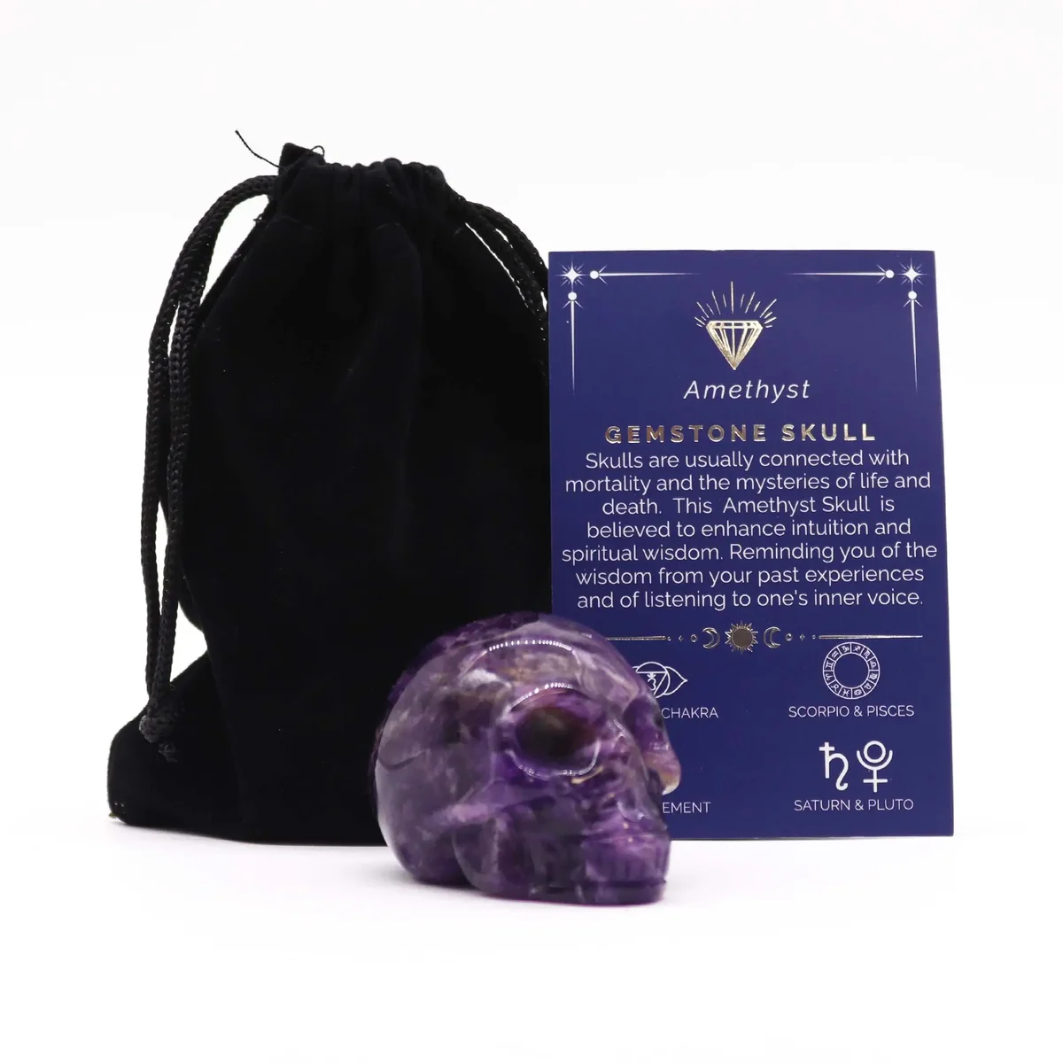 Large gemstone skull carved from purple amethyst with detailed features on a white background