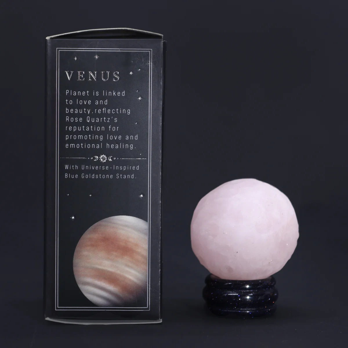 Rose Quartz sphere representing Venus resting on a sparkling sola goldstone stand against a white background