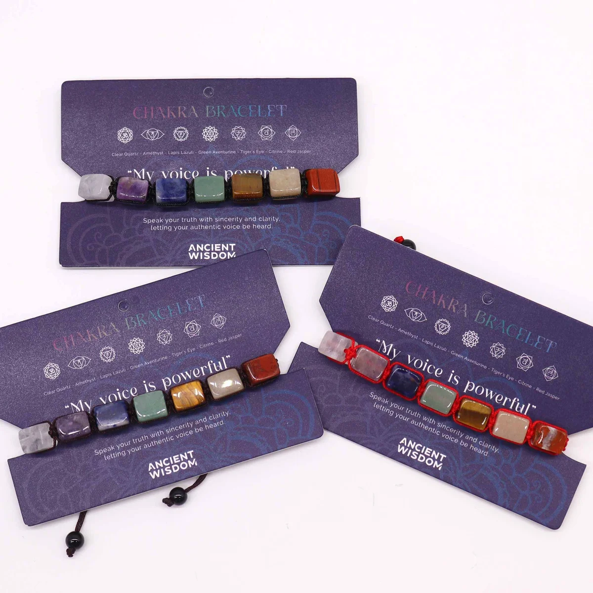 Chakra string bracelet featuring colorful tumble stones on an adjustable cord against a white background