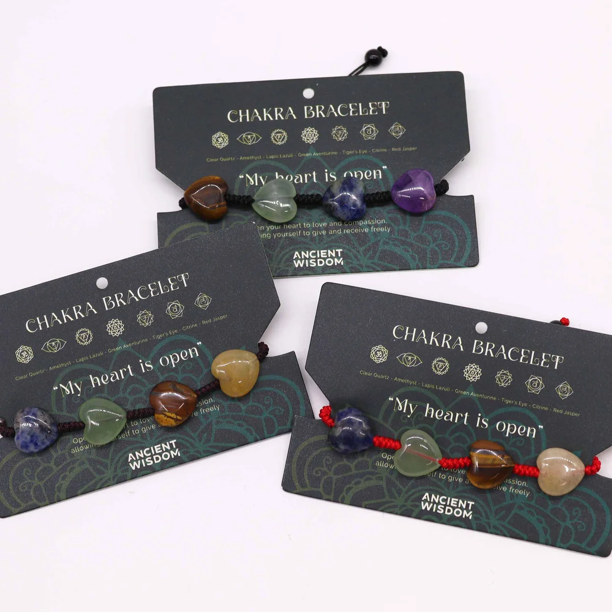 Chakra string bracelet UK featuring colorful heart-shaped beads on a delicate string band against a white background