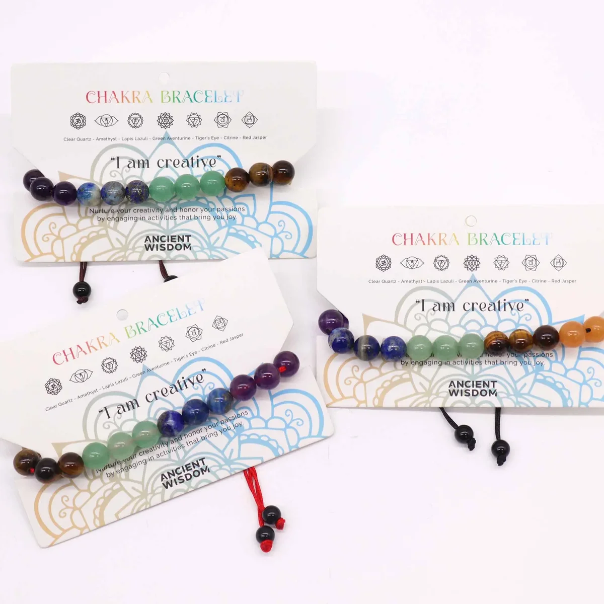 Chakra string bracelet featuring 21 colorful stones on an adjustable cord, designed for balance and energy.