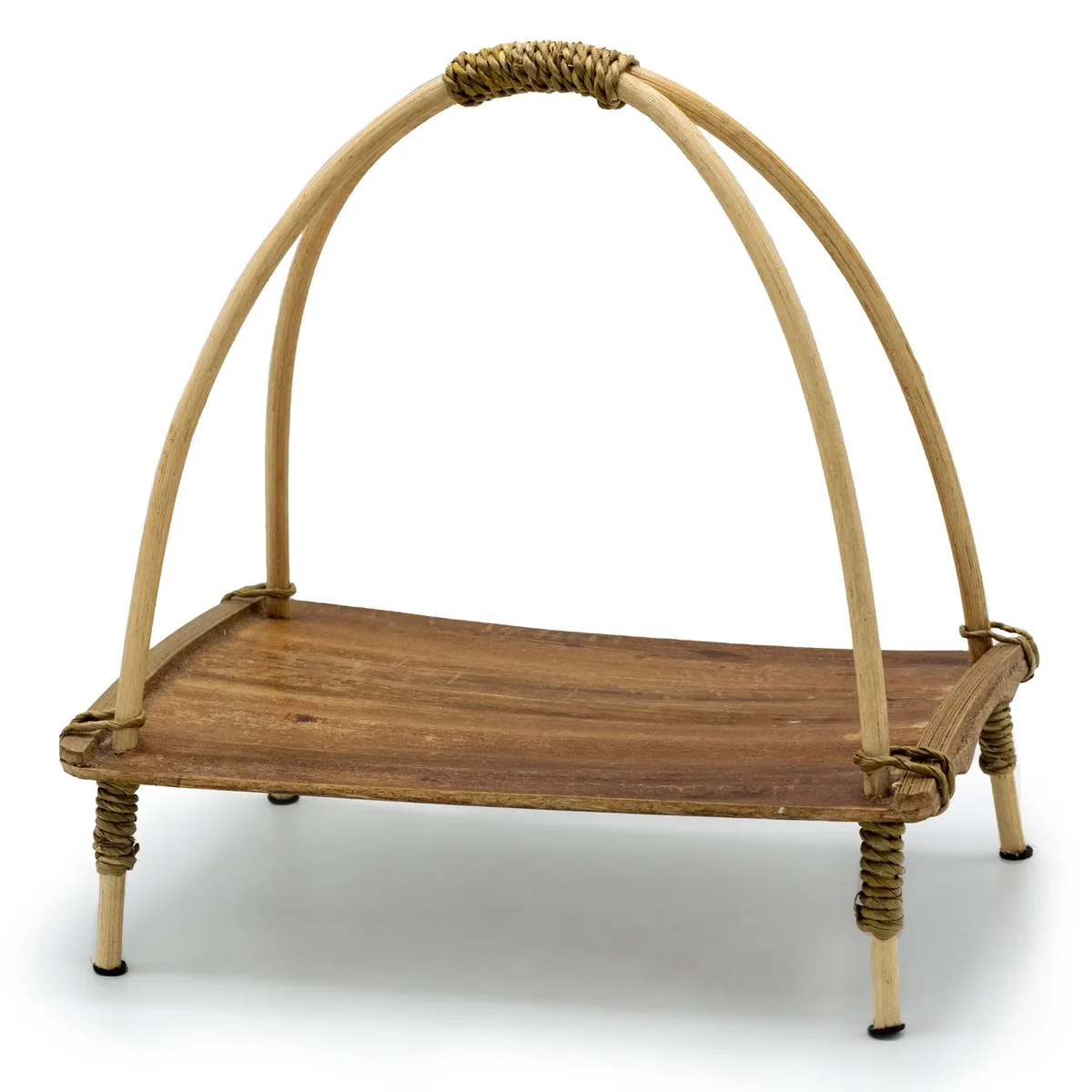 Natural coconut leaf tea stand with a woven design for holding cups and teapots on flat surface