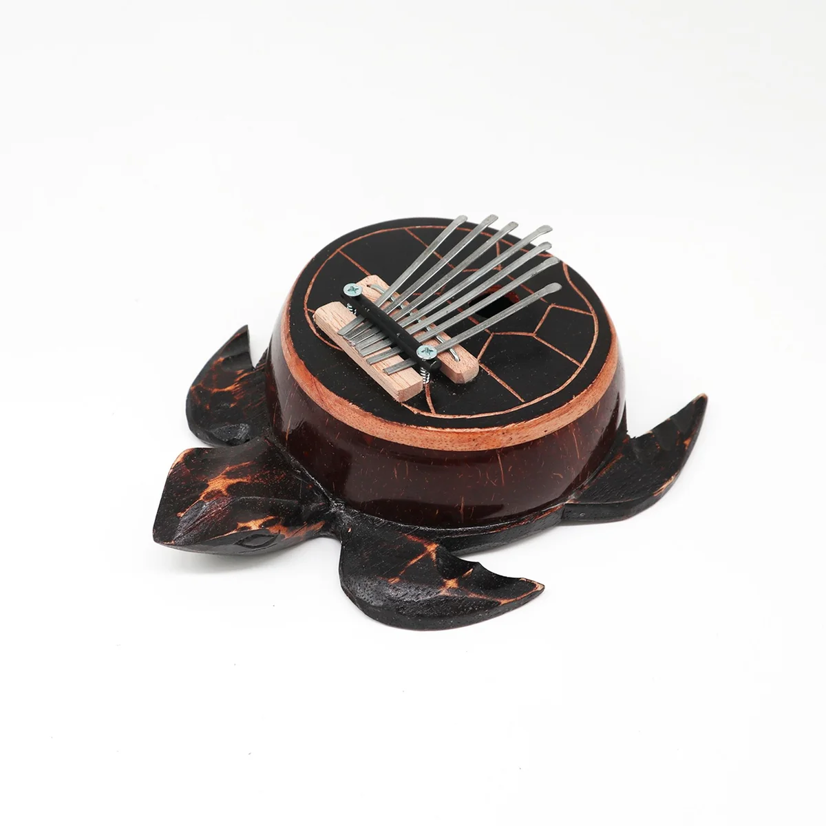 Antique turtle kalimba made from coconut shell with carved turtle design and metal tines for playing music