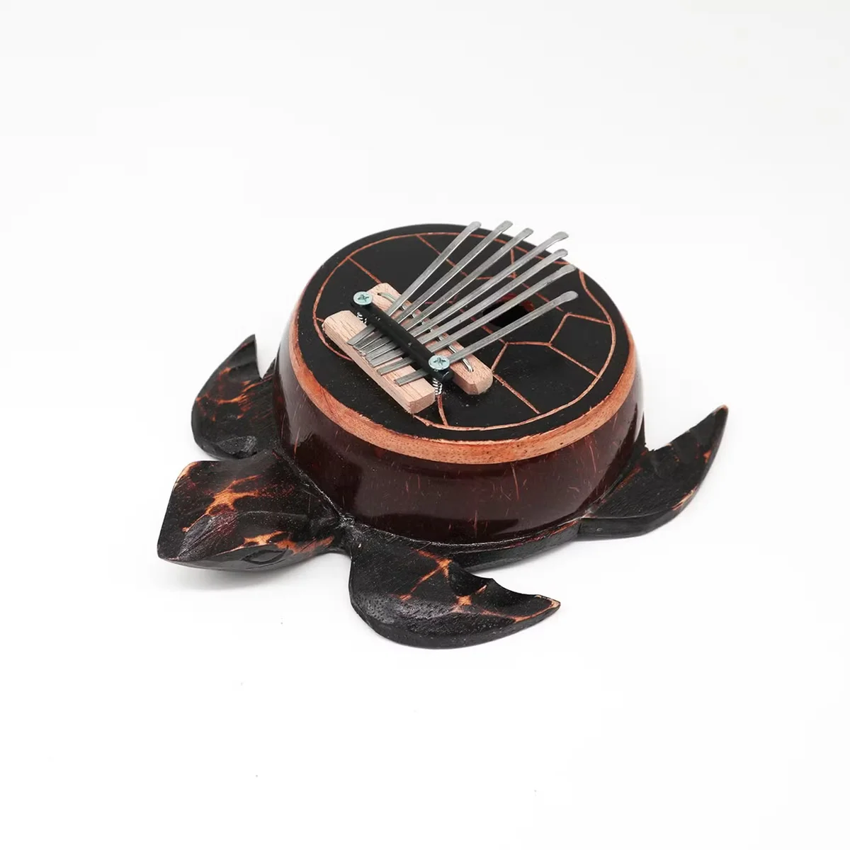 Antique turtle-shaped kalimba made from coconut shell, a unique musical gift with natural wood texture and metal tines