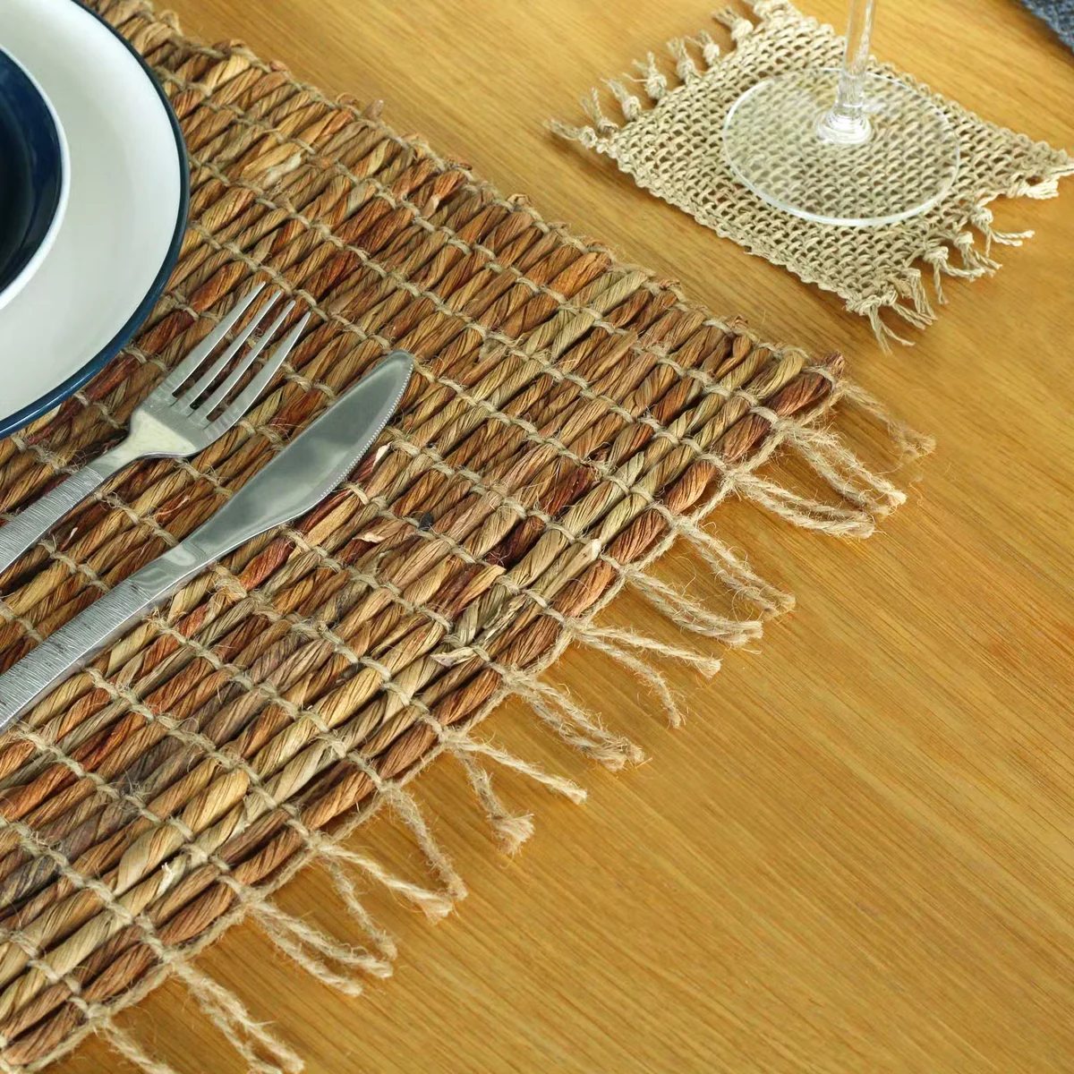 Water hyacinth natural placemat with robust texture and fringe edges, eco friendly placemat for dining table use