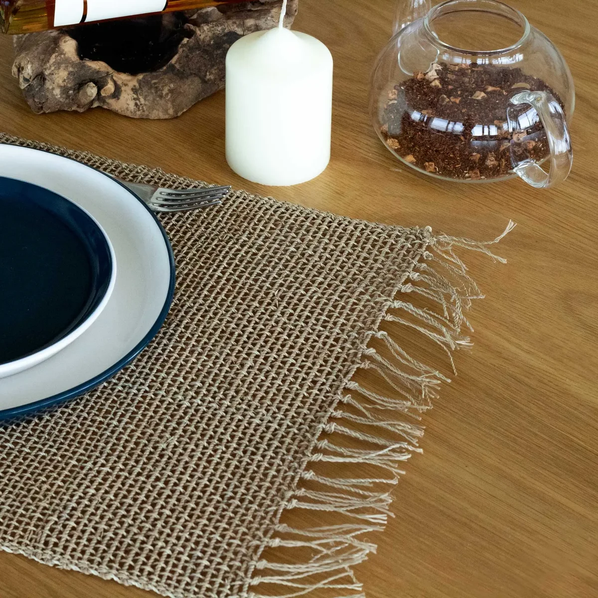 Seagrass fringe natural placemat in natural color with woven texture on a white background