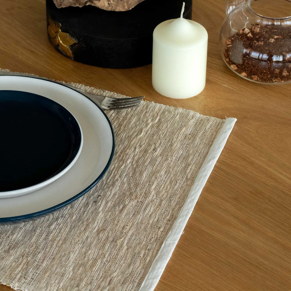 Natural placemat made from woven vetiver roots with a rustic, earthy texture and neutral tones on a white background