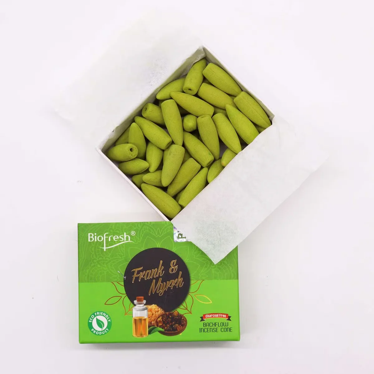 Biofresh incense cones in frankincense and myrrh scent arranged on a wooden surface with smoke flowing downwards