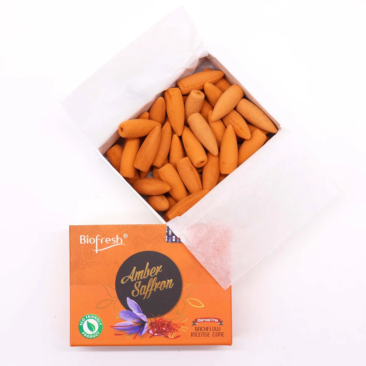 Biofresh Amber Safron backflow incense cones arranged with smoke flowing downwards on a dark surface