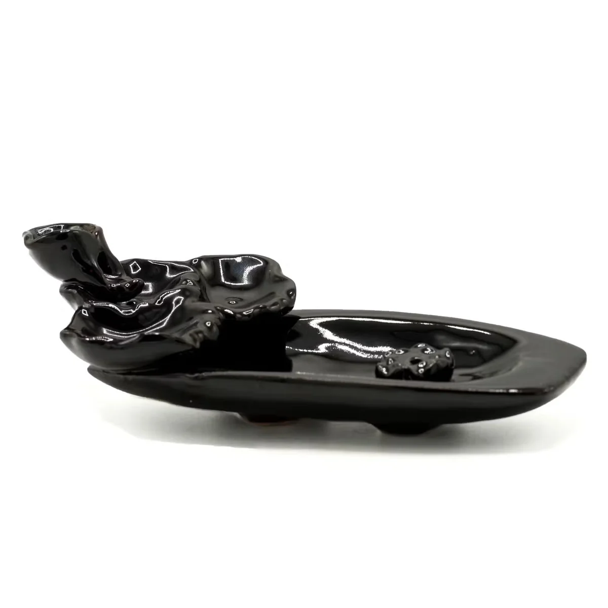 Decorative incense burner shaped like a lotus pond with incense stick holder releasing backflow smoke
