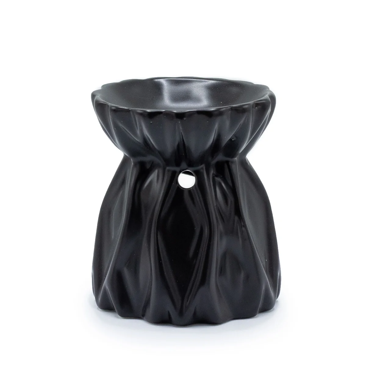 Black geometric oil burner on a neutral background.